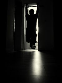 Silhouette woman standing in corridor