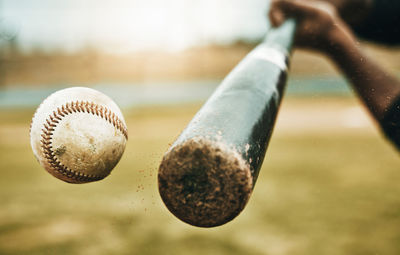 Cropped hand holding baseball