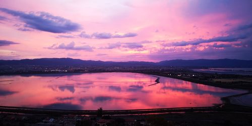 Scenic view of lake against romantic sky at sunset