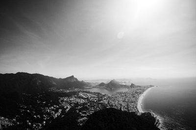 High angle view of sea and mountains against sky