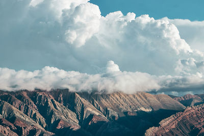 Aerial view of mountain range against cloudy sky