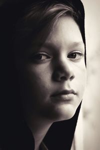 Close-up portrait of beautiful young woman over gray background