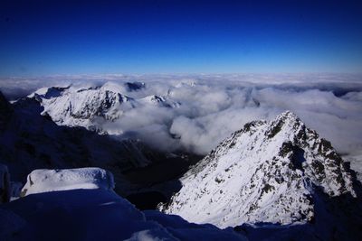 Scenic view of mountains against cloudy sky