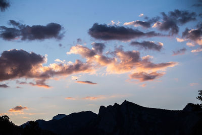 Low angle view of silhouette mountain against sky at sunset