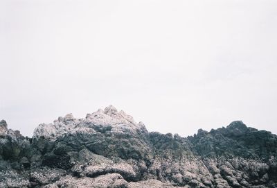 Rock formations on landscape against sky