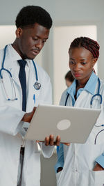 Doctors looking at laptop in hospital