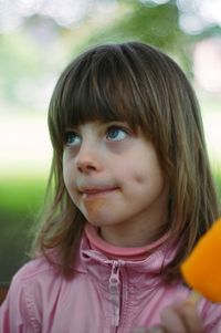 Closed-up of girl eating flavored ice at park