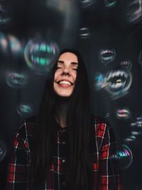 Smiling young woman standing at night