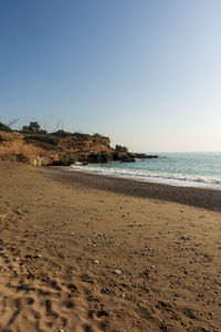 Scenic view of beach against clear sky