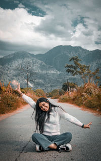 Portrait of woman standing on road