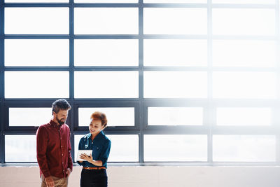 Man and woman standing in window