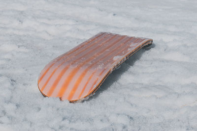 A close-up shot of a snowskate lying in the snow at a french ski resort