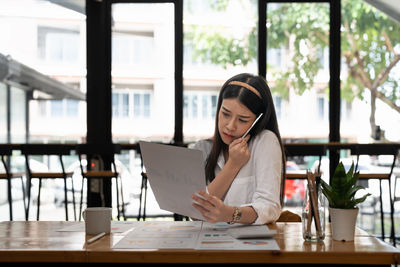 Businesswoman using laptop at office