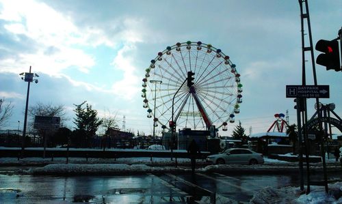 Low angle view of ferris wheel against sky