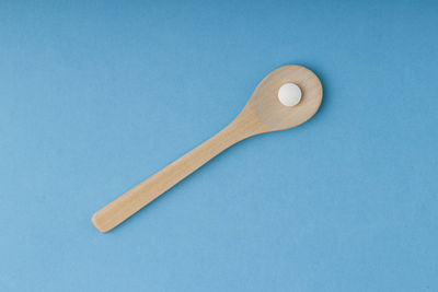 High angle view of fork against blue background