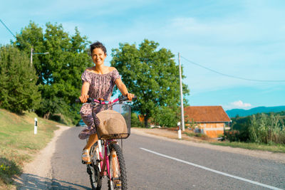 Portrait of man riding bicycle on road