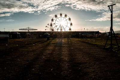 Ferris wheel against sky on sunny day