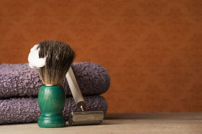 Close-up of shaving equipment on table