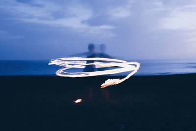 Light paint of fire dancer at the beach of valle gran rey la gomera 