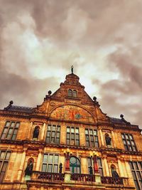 Low angle view of historical building against cloudy sky