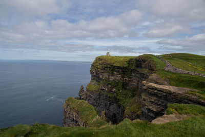 Rock formations by sea against sky