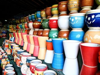 Close-up of multi colored containers at market stall