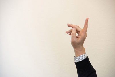 Close-up of man hand against white background