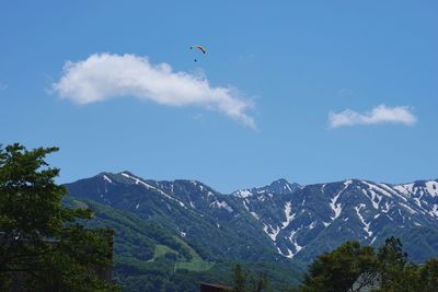 Scenic view of mountains against blue sky