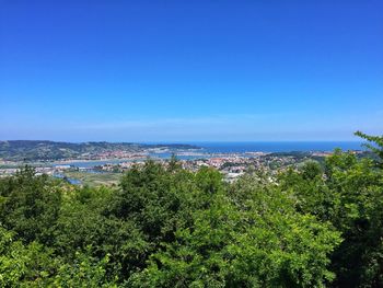 High angle view of townscape against blue sky