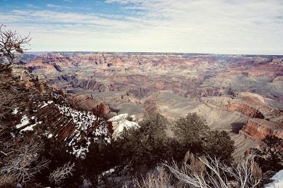 Aerial view of snow covered land against sky