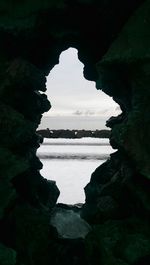 Scenic view of sea seen through cave