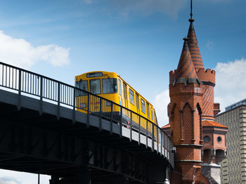 Low angle view of train on oberbaum bridge against sky