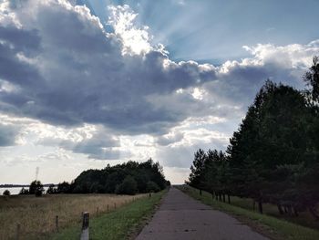 Empty road along countryside landscape