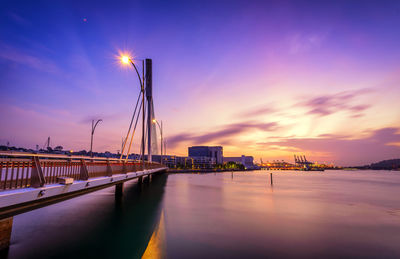 Bridge over sea at sunrise