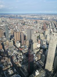 High angle view of modern buildings in city against sky