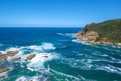 Scenic view of sea against clear blue sky