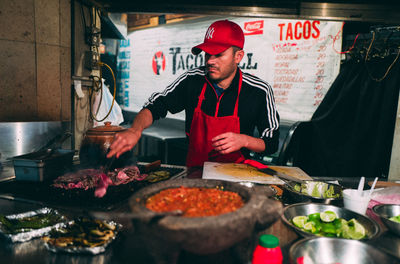 Midsection of man preparing food in restaurant