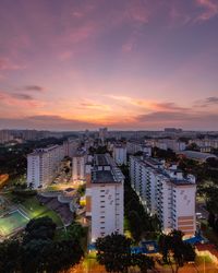 High angle view of illuminated buildings against sky at sunset