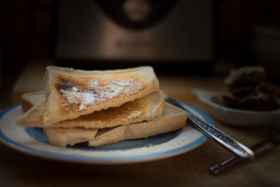 Close-up of breads in plate on table