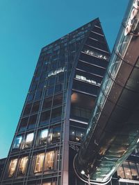 Low angle view of modern building against clear blue sky