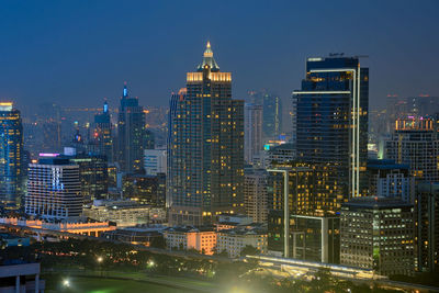 View of skyscrapers lit up at night