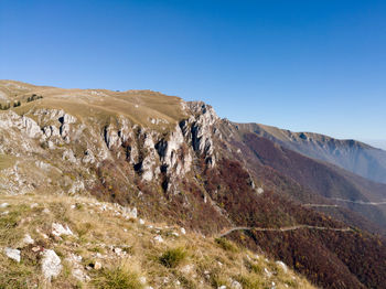 Scenic view of rocky mountains against clear blue sky