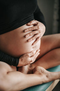 Low section of woman sitting at home