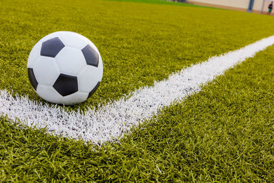 Close-up of soccer ball on field