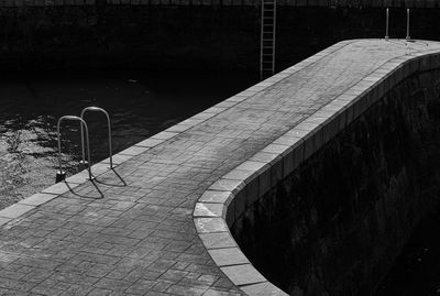 High angle view of empty footpath by street