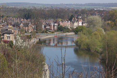 Scenic view of river by trees against sky