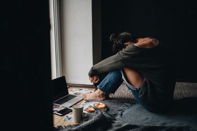 Thoughtful woman siting at home