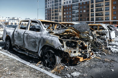 Few burnt out cars. not recoverable vehicles destroyed by fire. rusty pile of metal. insurance case.