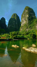 Small river against backdrop of the yellow mountains in china. tourist district