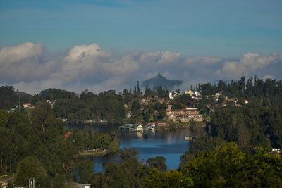 Scenic view of lake and buildings against sky